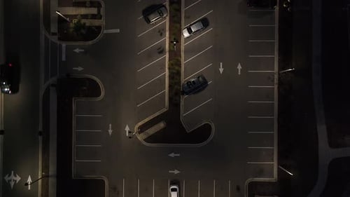 Night time parking lot, downward angle drone, aerial shot