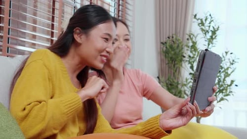 Cheerful Women Video Chatting at Home with Tablet
