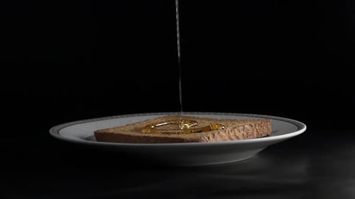 hot and toasted bread Honey drop in slow motion over