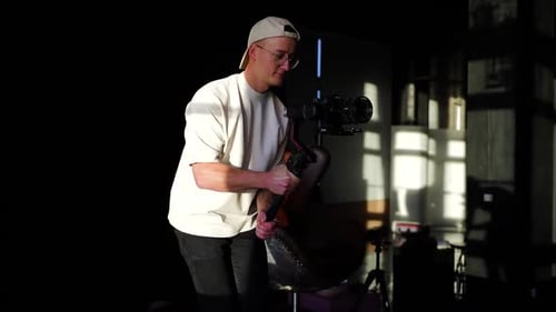 Videographer with gimbal stabilizer camera equipment walk smoothly in studio