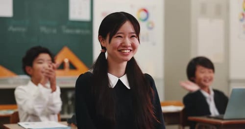 Smiling Student Receives Applause in Classroom Setting