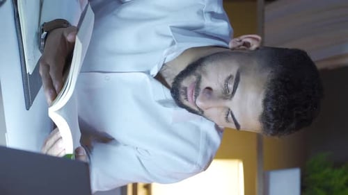 Young Adult Dozing Off While Reading a Book