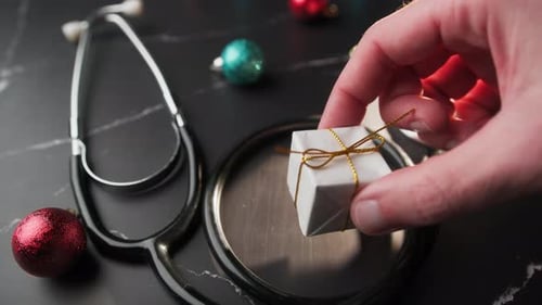 Doctor with Stethoscope Takes a Break for Christmas Background with Balls