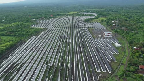 Aerial view of solar farm with mount agung volcano in bali indonesia