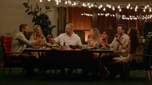 Friends Toasting Wine at Evening Dinner Party