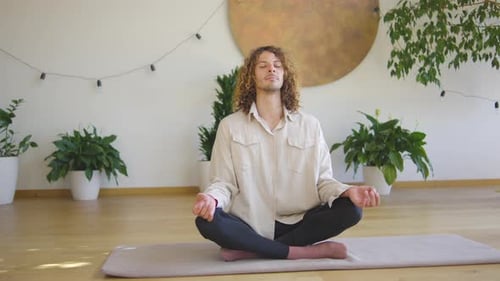 Young Adult Meditating in Bright Indoor Setting