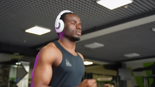 Black Man at the Gym Doing Exercise on the Treadmill