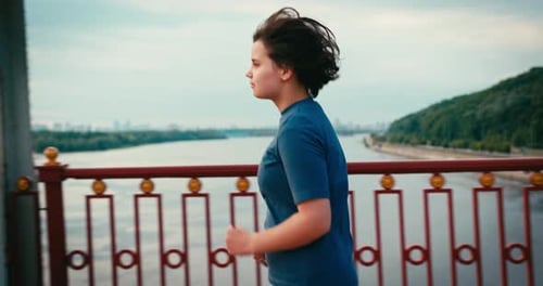 Woman Runs on Bridge on a Sunny Day