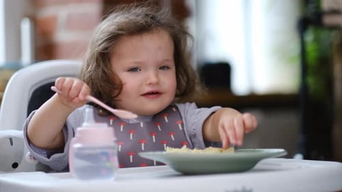Adorable Toddler Enjoying Pasta at Mealtime