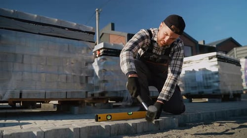Craftsman Leveling Pavers for Suburban Construction