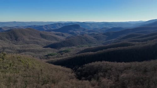 Experience Stunning Mountain Ranges and Serene Valleys in This Aerial Video