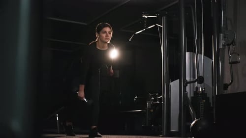 Athletic Woman Lifting Heavy Dumbbell to Train Her Arm Muscles