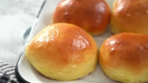 Step By Step Freshly Baked Brioche Buns on a Metal Serving Tray