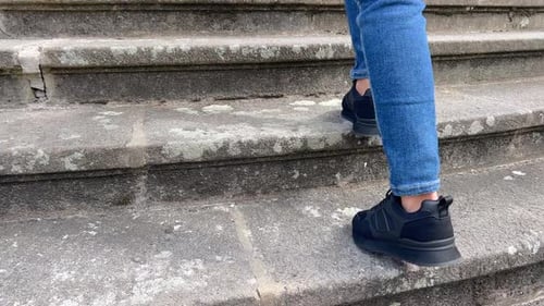 Person Walking Up Concrete Urban Staircase Outdoors