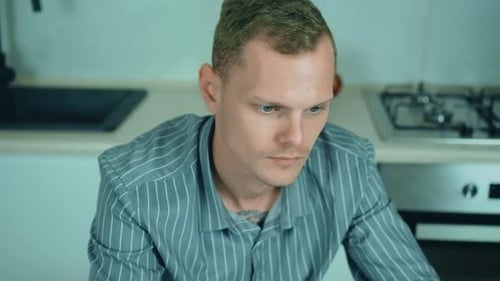 Professional Creative Man Sitting at His Desk in Home Office Studio Working Typing on Laptop