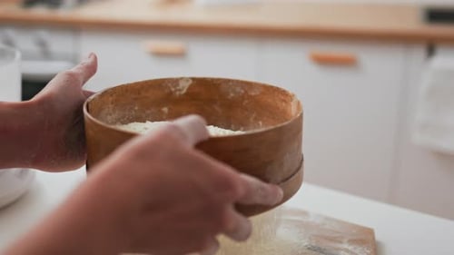 The Baker In The Home Kitchen Sifts Flour Through A Sieve White Flour Falls Sifting Through The Mesh
