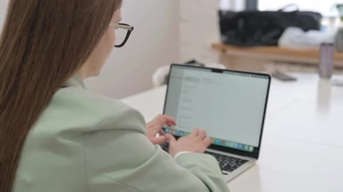 Rare View of Business Woman Typing on Laptop