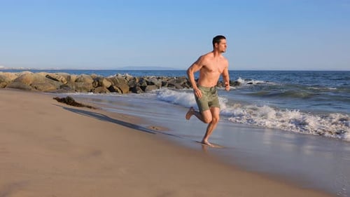 Athletic Man Exercising At The Beach