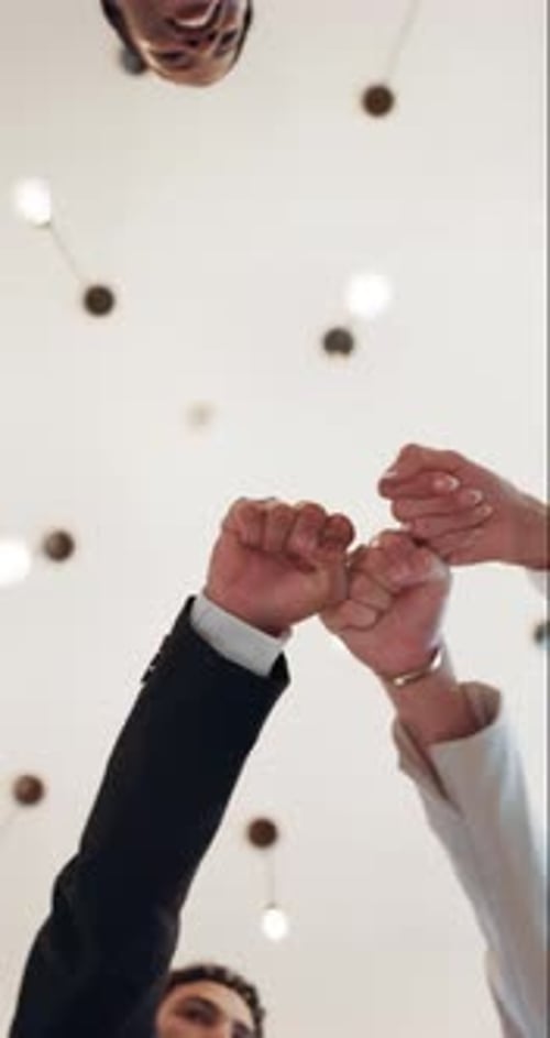 Fist bump, below and hands of business people in circle for teamwork, collaboration and partnership