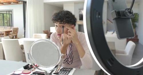 Young Adult Applying Makeup with Ring Light