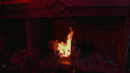 Glowing Fire Burns in Forge at Night