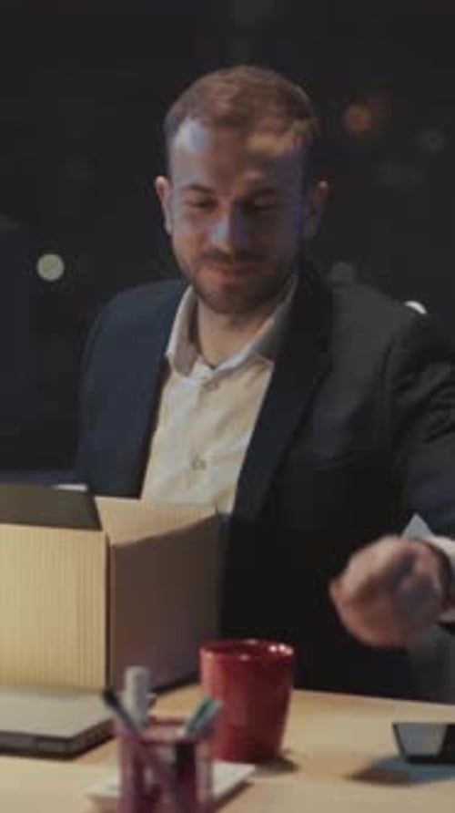 Evening Office Worker Packs Belongings Quietly Employee Prepares to Leave After Working Late Into