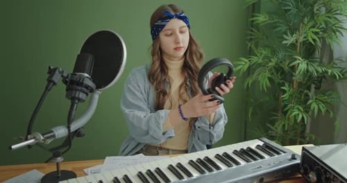 Young Musician Playing in Studio with Equipment