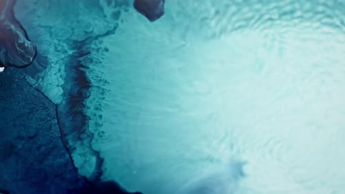 Crystal blue ink spreading in clear water creating an abstract pattern