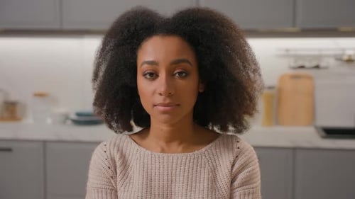 Woman Posing With Curly Hair In Kitchen