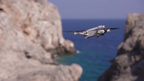 Drone Hovering Above Azure Waters and Rocky Cliffs