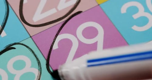 CloseUp of Number 29 Circled on Colorful Calendar with Black Pen