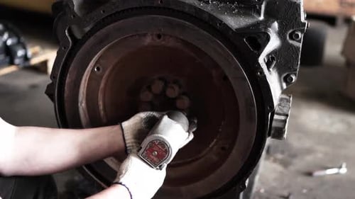 Close Up of Mechanic Using Power Tool on Engine