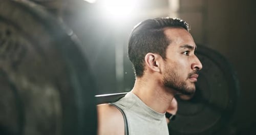 Man at gym, weight lifting and barbell for muscle building endurance, strong body