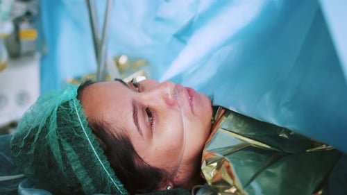 Gros plan d'un patient allongé sur une table d'opération sous anesthésie avec tube respiratoire