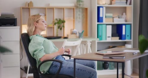Woman Relaxing at Her Desk in Home Office