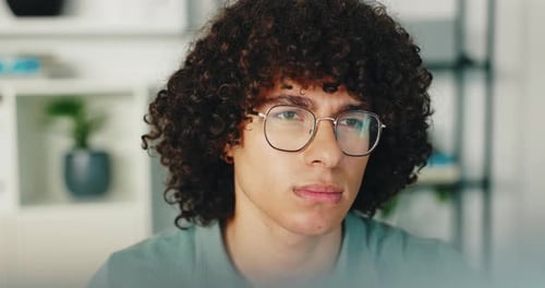 Thinking, serious and programming in office, man and IT specialist with glasses, planning or online