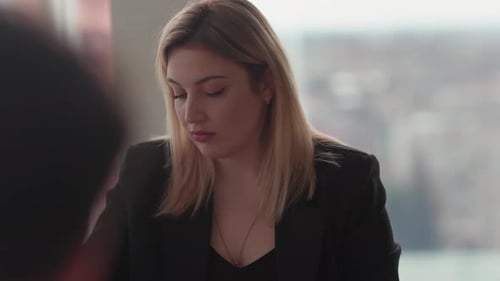Young Woman Reviewing Documents in Office