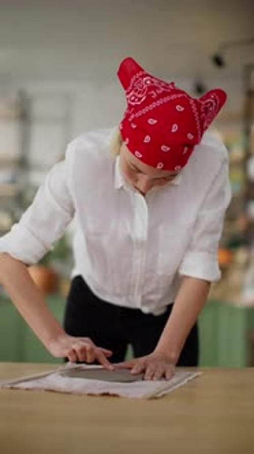 Focused Artisan Shaping Pottery Clay on Workbench in Art Studio with Concentration and Skillful