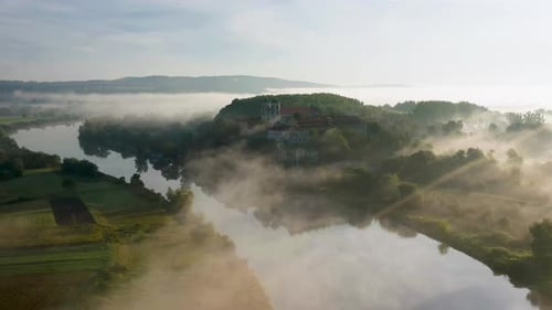 Aerial drone view of Benedictine Abbey over Vistula river in Tyniec in the morning fog, Krakow, Pola
