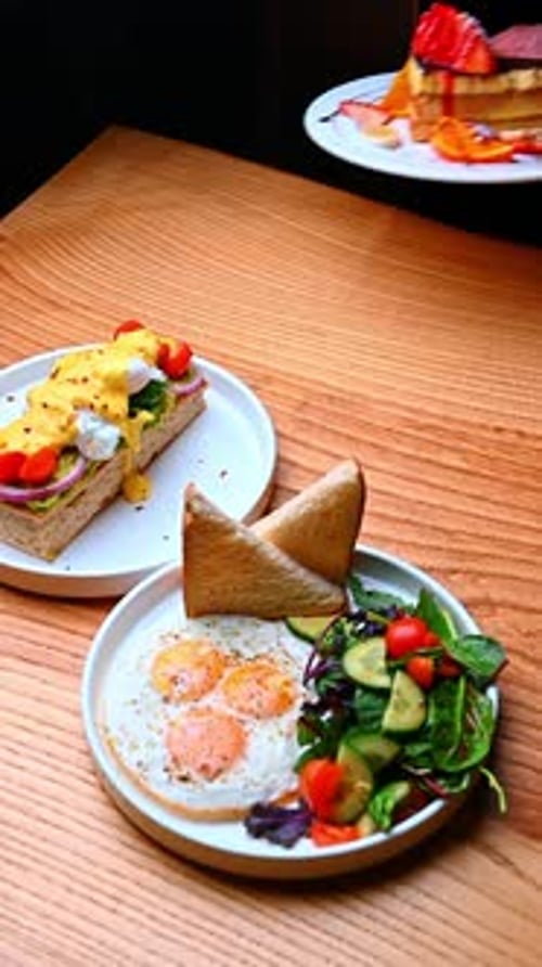 Breakfast Food Variety on Table Served by Hand