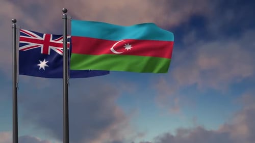 Australian and Azerbaijan Flags Waving Against a Cloudy Sky