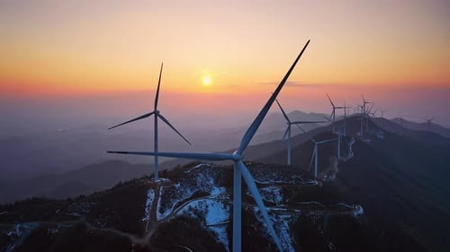 Scenic Wind Turbines Spinning Slowly at Sunrise