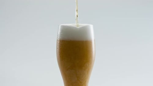 Filling Glass Golden Beer in Super Slow Motion Close Up