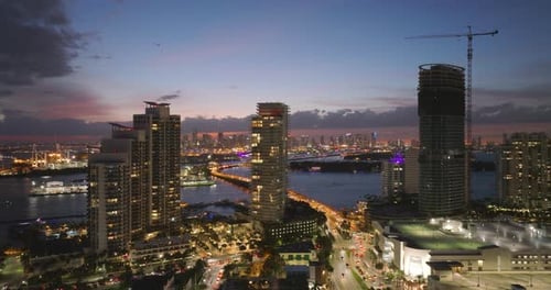 Tower Crane at High Residential Apartment Building Construction Site at Night Real Estate