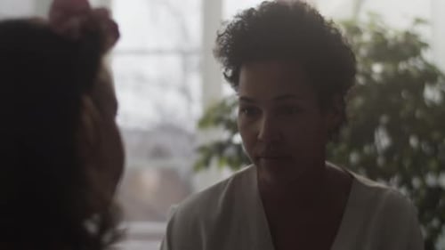 Woman Talking to Child Indoors During the Day