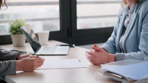 Video of close up of attractive real-estate agent shaking hands with homan after signing agreement