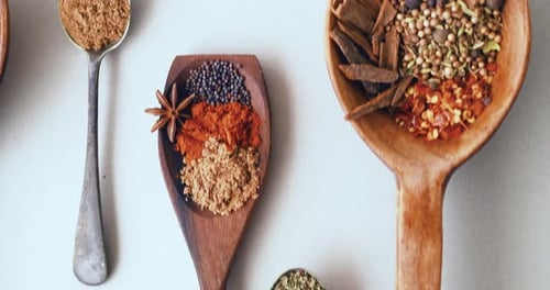 Spices, herbs and seeds for seasoning, spoon and studio for curry, condiments and choice