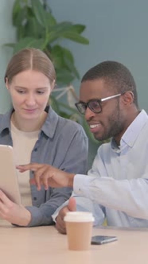 Multiethnic Young Business People Working on Tablet in Office, vertical video