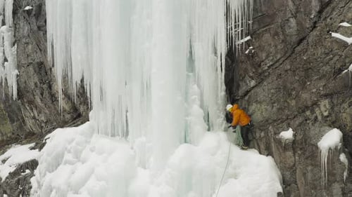 Stunning frozen cascade climber assessing buddies rope Aerial