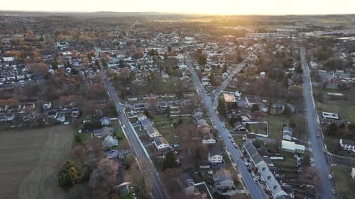 American town with several straight main streets in neighborhood. Sunset time in winter season. Aeri